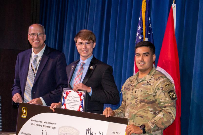 A student is honored for serving in the US Armed Forces after high school